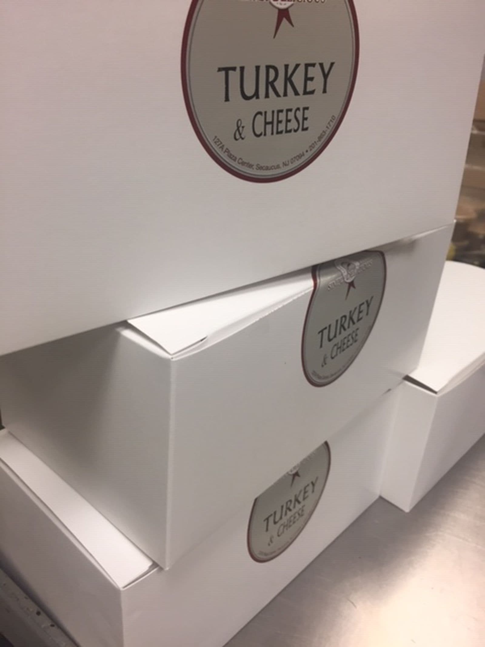 Boxed lunches labeled Turkey & Cheese ready for an office delivery in New Jersey